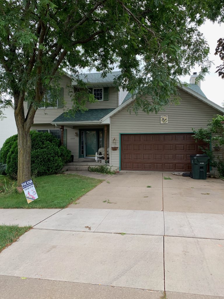 Exterior of a suburban home with a Five Star Home Improvement yard sign, showcasing a residential roof inspection and roofing services for detecting shingle damage, leaks, and storm-related roof issues.