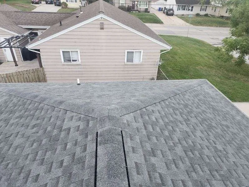 Completed residential roof replacement in Cedar Rapids, IA with Owens Corning TruDef Duration shingles in Williamsburg Grey.
