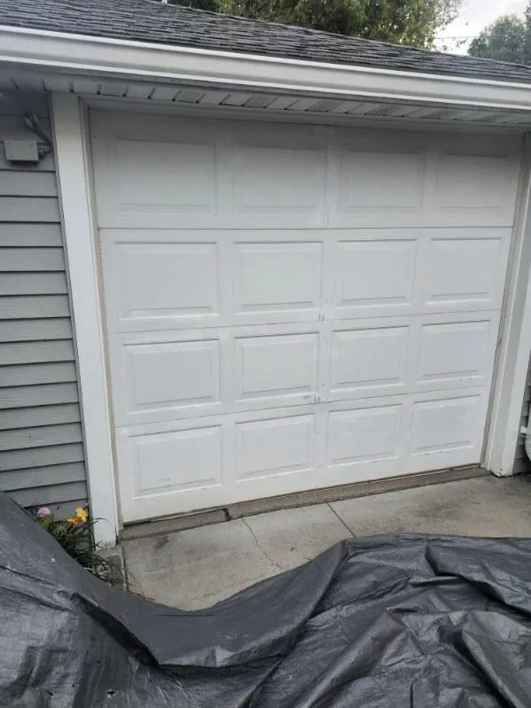Garage area protected with tarps during a residential roof replacement in Cedar Rapids, IA.