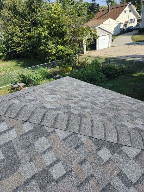 Close-up view of Owens Corning TruDef Duration shingles in Williamsburg Grey on a residential roof in Cedar Rapids, IA.