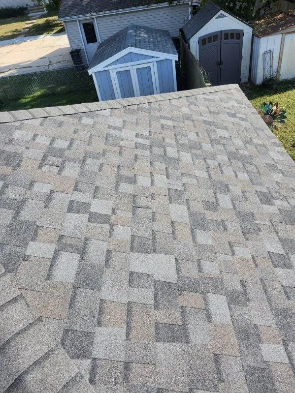 Close-up view of Owens Corning TruDef Duration shingles in Williamsburg Grey on a residential roof in Cedar Rapids, IA.