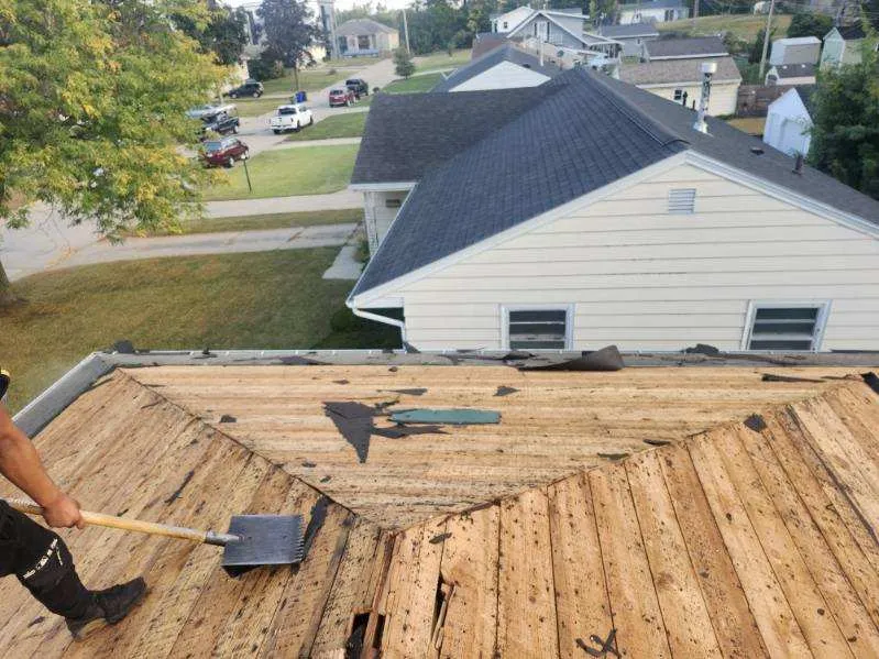 Roof tear off in progress on a residential home in Cedar Rapids, IA during a full roof replacement.